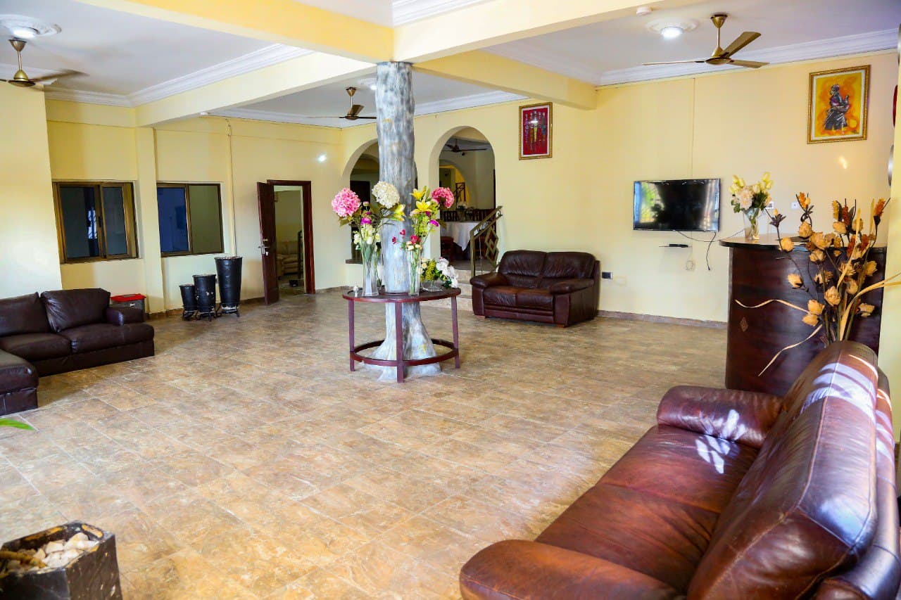 Open lounge with rattan armchairs and terracotta floors